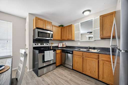 A kitchen with wooden cabinets and stainless steel appliances.