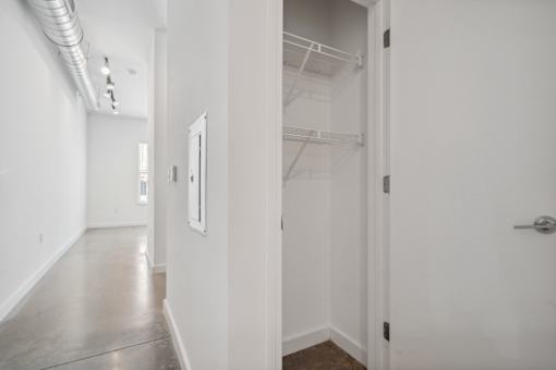 A white hallway with a door on the right.