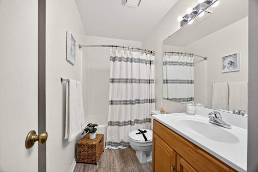 A bathroom with a white toilet and a white sink.