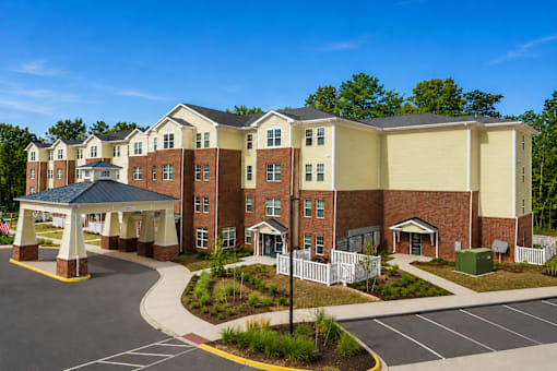 A large building with a covered walkway in front.