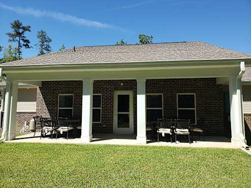 A house with a covered patio and a white door.