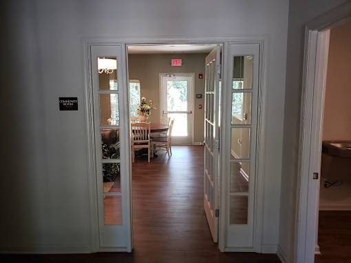 A hallway with a sign that says "EXIT ONLY" on the wall.