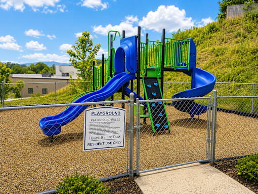 A playground with a blue slide and a sign that says "Playground Rules".