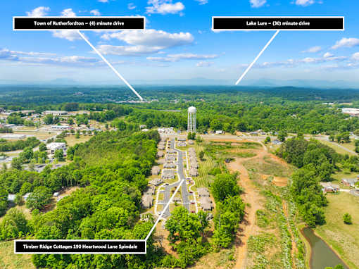 An aerial view of a residential area with Timber Ridge Cottages 390 Heartwood Lane Spindale.