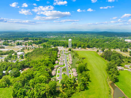 A bird's eye view of a residential area with a large water tower in the center.