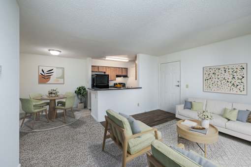 A living room with a white couch, a coffee table, and a television.