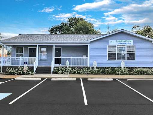 A blue building with a sign that says Leasing Center.