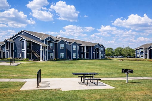 A row of houses with a picnic table in front.