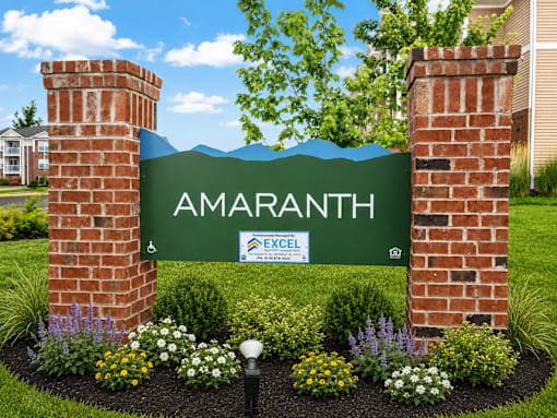 A sign that says "Amaranth" is flanked by two brick towers.