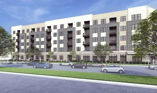 A modern apartment building with cars parked in front.