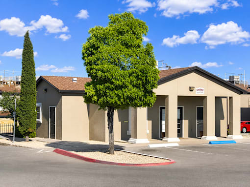 A building with a tree in front of it.