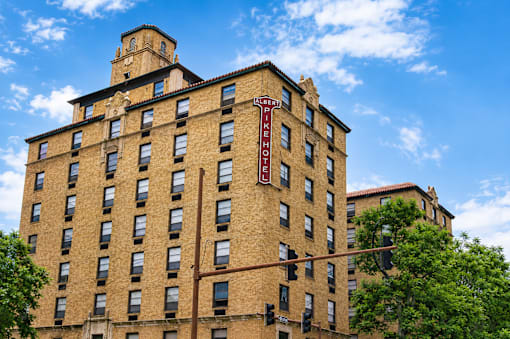 A tall brick building with a clock tower on the top.