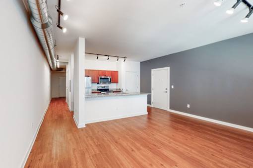 A room with wooden floors and a white counter.
