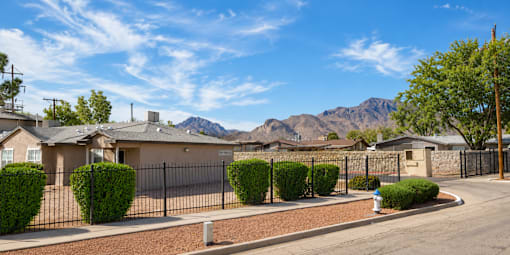 A residential area with houses and a mountain in the background.