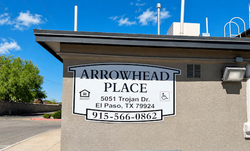 A sign for Arrowhead Place in El Paso, TX is displayed on a building.