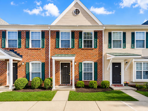 A two-story house with a brick facade and white trim.