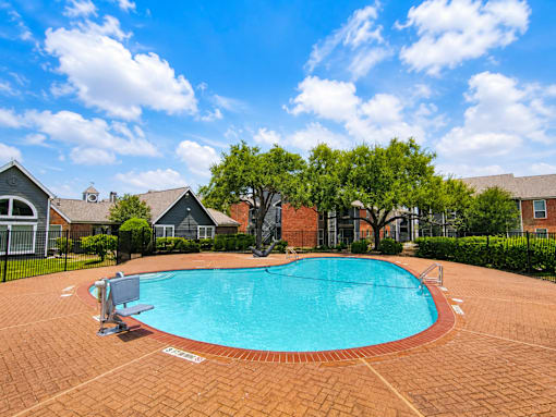 A small pool surrounded by a brick patio.