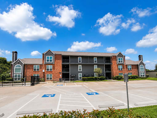 A large building with a parking lot in front of it.