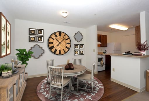 a dining room with a table and chairs and a clock on the wall