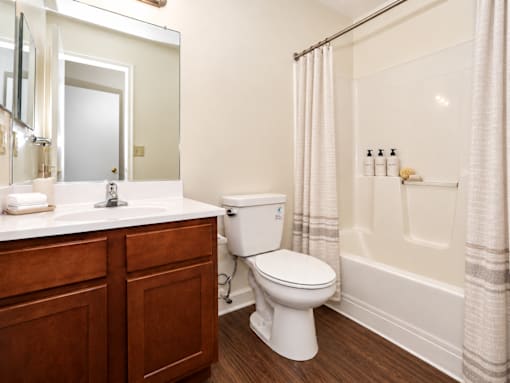 A white toilet sits next to a white sink in a bathroom.