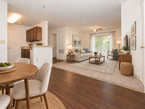 A modern living room with a dining table and chairs.