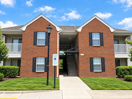 A red brick building with a blue sign in front.
