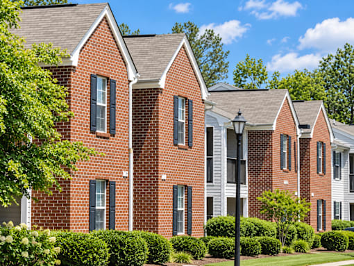 A red brick building with white trim and black shutters.