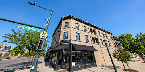 A street view of Josephine St with a building on the corner.