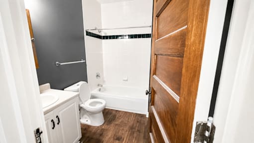 A bathroom with a toilet, a sink, and a bathtub.