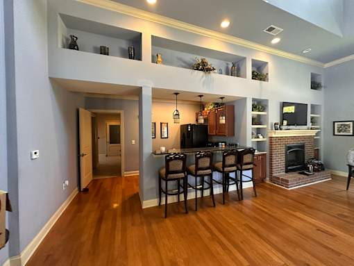 a living room with a fireplace and a table with chairs