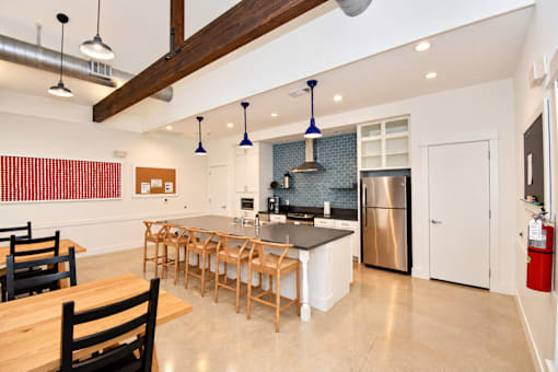 The community kitchen in the clubhouse with a large island and fridge