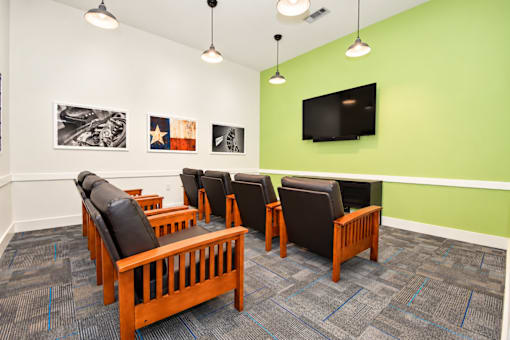 Media room with comfy chairs and large TV