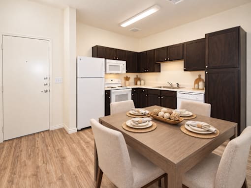 A kitchen with a table set for four.