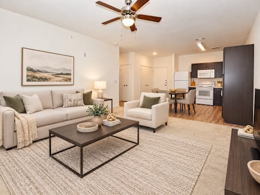 Living room with couch, chair and coffee table.