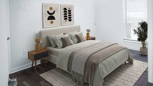 A bedroom with a bed, pillows, a nightstand, and a plant.