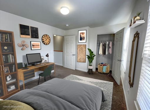 a bedroom with a bed and a desk and a closet