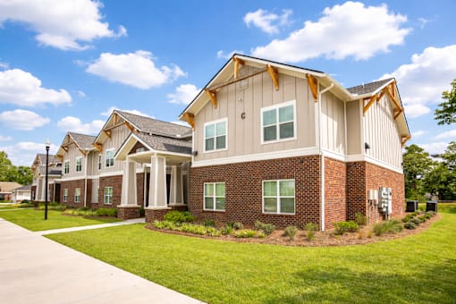 A modern house with a combination of brick and siding exterior.