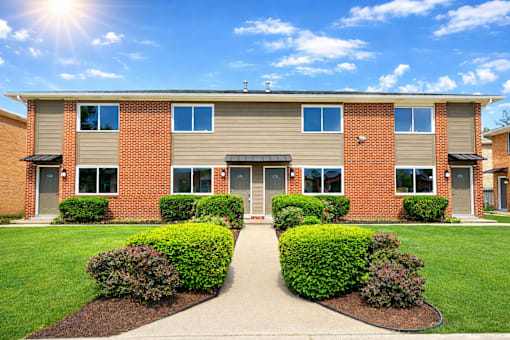 A sunny day at a residential building with a clear blue sky.