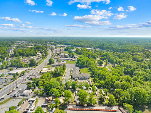 A bird's eye view of a city with roads, buildings, and trees.