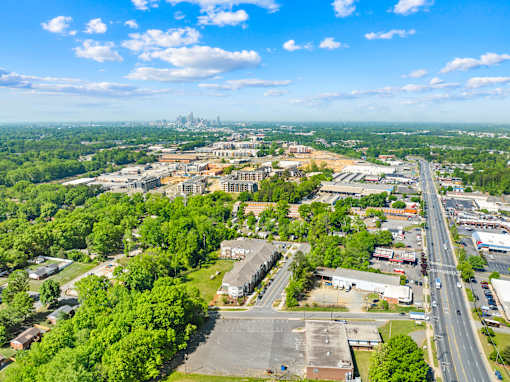 A cityscape with a clear blue sky and a distant city skyline.
