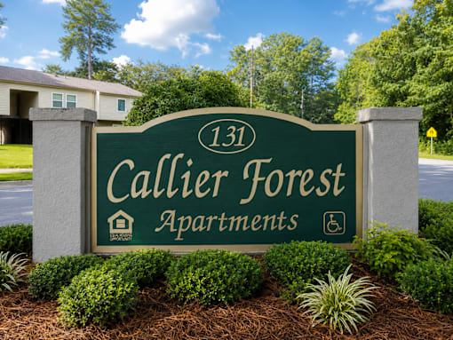 A sign for Callier Forest Apartments is displayed in front of a building.