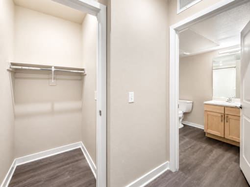 A small, empty room with a toilet and sink in the background.