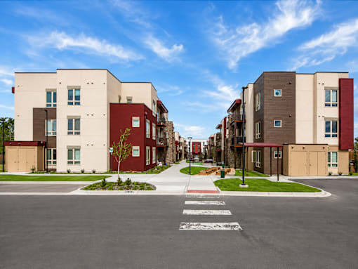 A street view of a residential area with apartment buildings on both sides.
