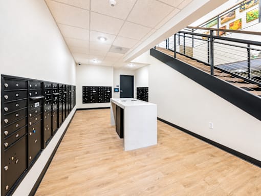A room with a white table and black lockers.