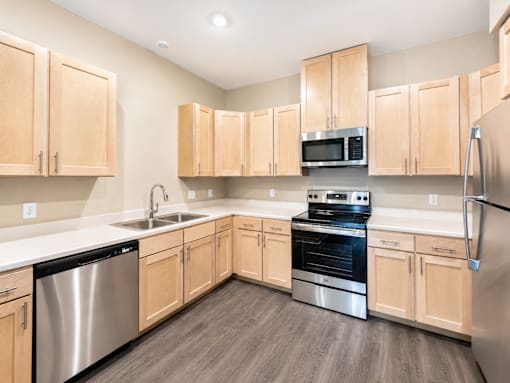 A kitchen with wooden cabinets and stainless steel appliances.