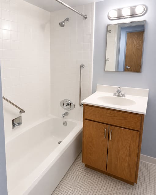 A white sink is on a counter in a bathroom.