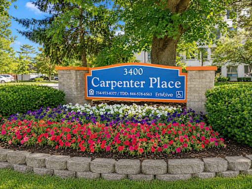 A sign for Carpenter Place with a phone number on it.