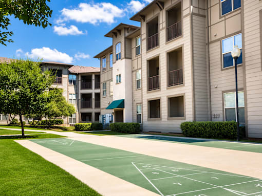 A basketball court is located in front of a building.