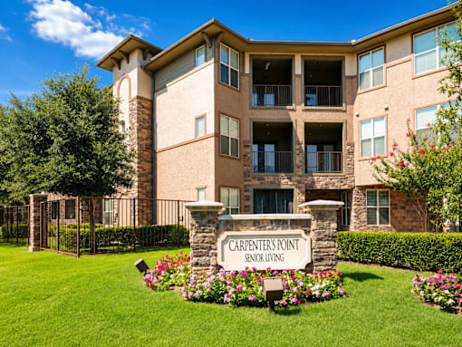 A building with a sign that says Carpenters Point Senior Living.