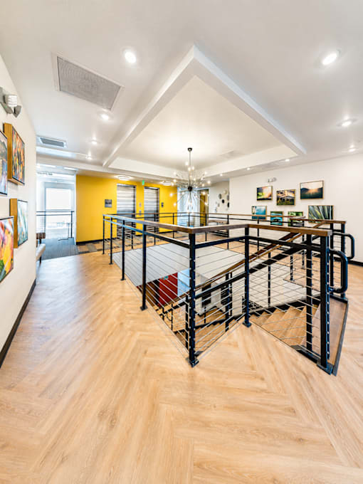 A black metal staircase with a wooden floor.